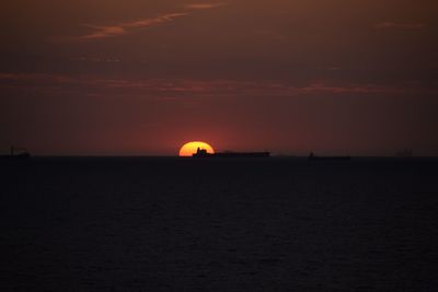 Scenic view of sea against orange sky