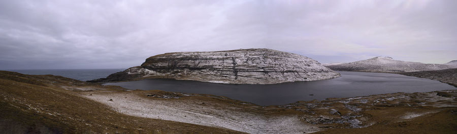 Scenic view of rocks in sea against sky