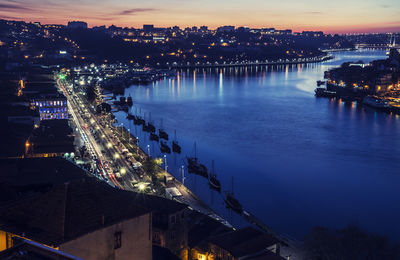 High angle view of city lit up at night