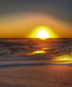 Scenic view of sea against orange sky