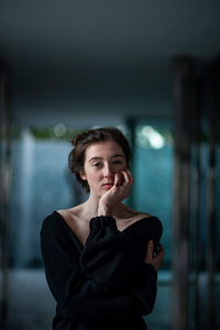 Portrait of young woman standing on floor