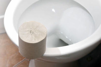 Toilet paper on commode at bathroom