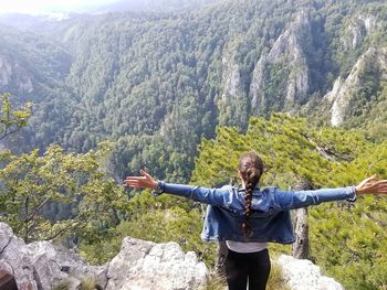 Full length of person standing on tree mountain