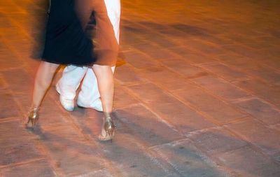 Low section of woman standing on tiled floor