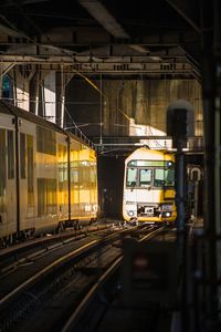 Train in illuminated railroad station at night