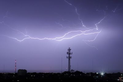 Lightning in sky over city at night