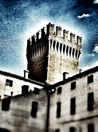 Low angle view of building against cloudy sky