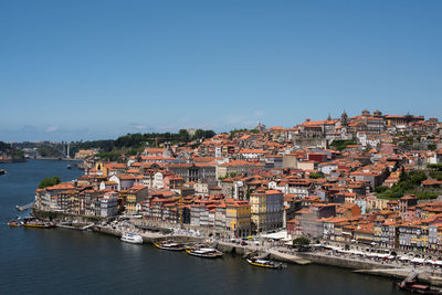 Boats in river with buildings in background