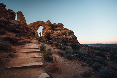 Rock formations on landscape against clear sky