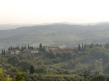 Scenic view of trees and buildings against sky