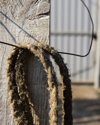 Close-up of rope tied on metal wall