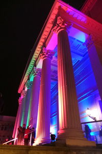 Low angle view of illuminated building against sky at night
