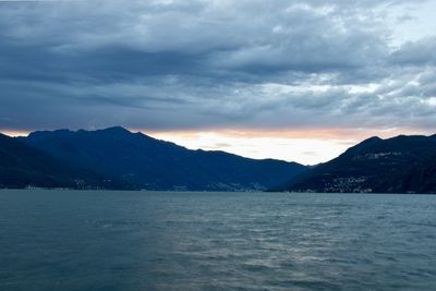 Scenic view of sea and mountains against sky
