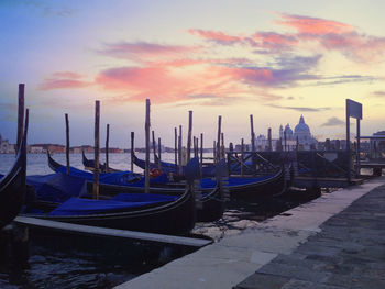View of boats moored at sunset