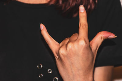 Close-up of person hand against black background