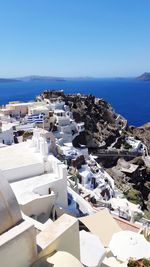 High angle view of townscape by sea against clear sky