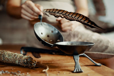 Woman with incense bowl and feather