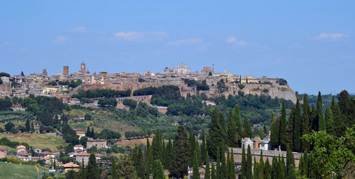 Buildings in town against sky