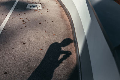 Low section of woman with shadow on hand