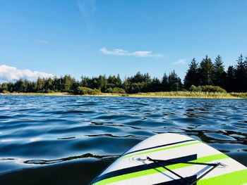 Scenic view of swimming pool by lake against sky