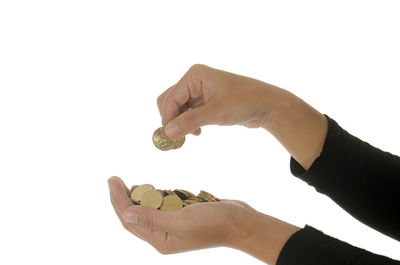 Midsection of person holding hands against white background