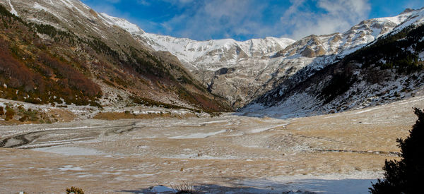 Scenic view of snowcapped mountains against sky