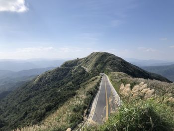 Scenic view of mountain road against sky