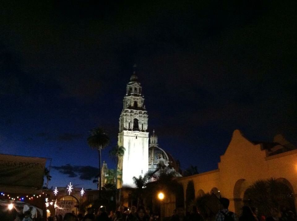 PEOPLE AT ILLUMINATED CATHEDRAL AT NIGHT