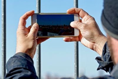 Man photographing cityscape from mobile phone