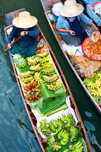 High angle view of vendors selling food at floating market