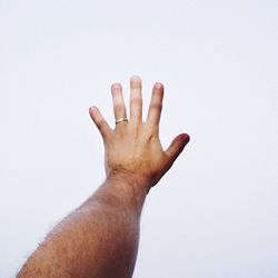 Cropped image of hand holding over white background