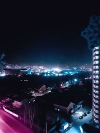 High angle view of illuminated city buildings at night