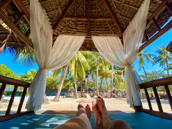 Low section of woman relaxing in hammock