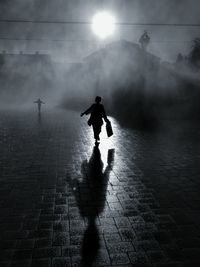People walking on street during foggy weather