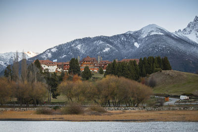 Scenic view of lake by mountains against sky