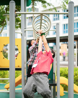 Kids playing on monkey bars at playground