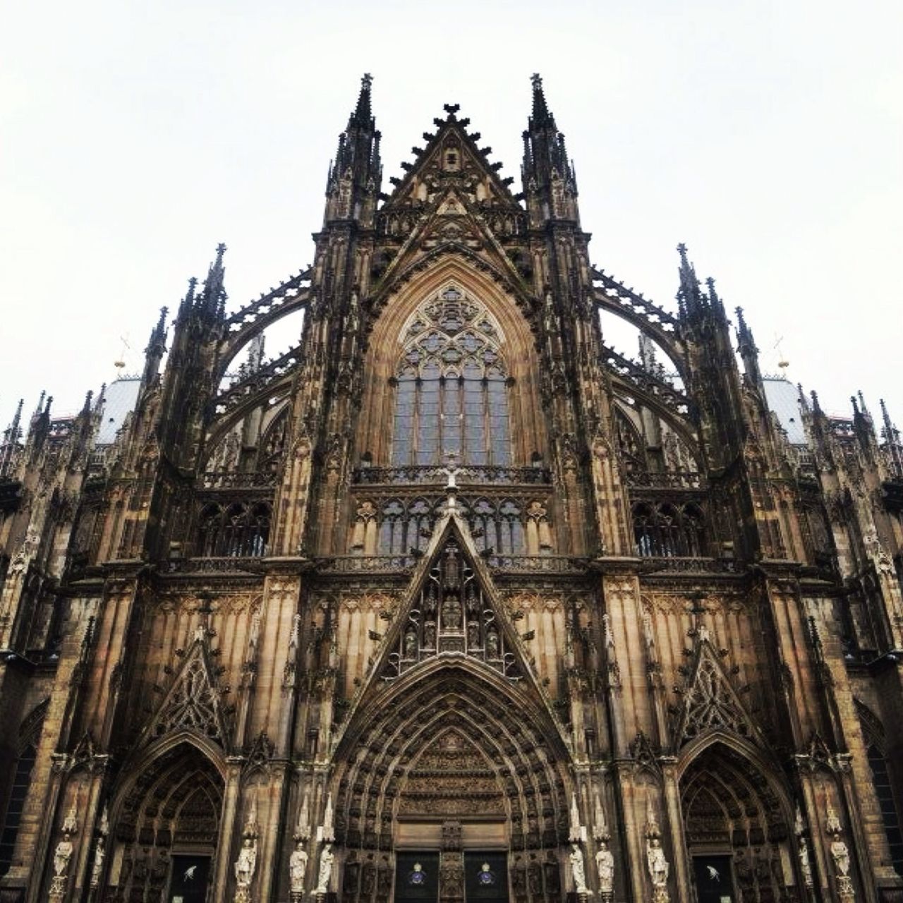 architecture, built structure, low angle view, building exterior, religion, church, place of worship, spirituality, cathedral, arch, facade, sky, history, clear sky, travel destinations, window, no people, day