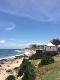 Houses on beach against sky