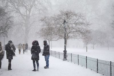 People on footpath during snowfall
