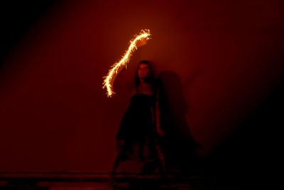 Young woman dancing at night