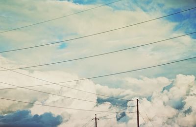 Low angle view of electricity pylon against sky