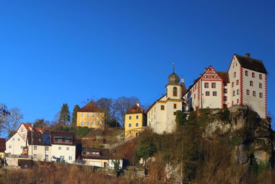 Low angle view of buildings against blue sky