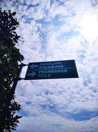 Low angle view of road sign against sky