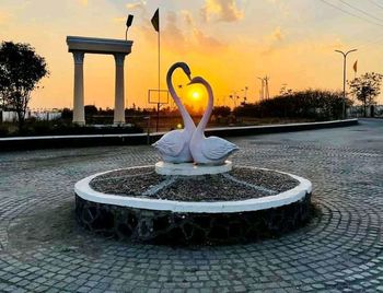 View of fountain in park at sunset