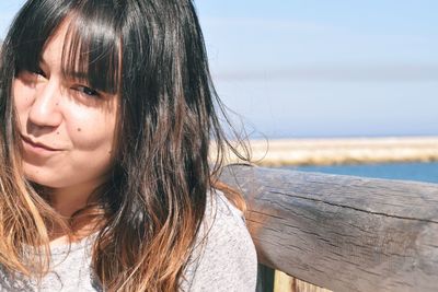 Close-up of girl against sky