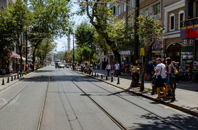 People walking on sidewalk in city