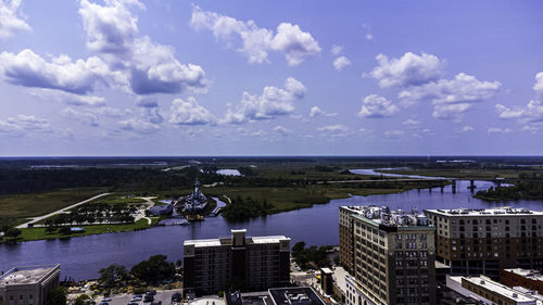 High angle view of buildings by sea against sky