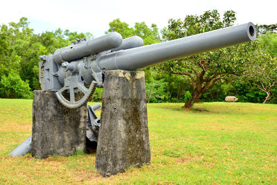 Metal structure on field against sky