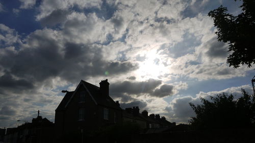 Low angle view of building against cloudy sky