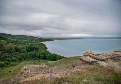 Scenic view of sea and mountains against sky